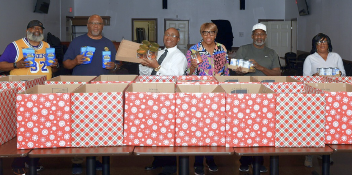 Legionnaires, Auxiliary, and Sons of the American Legion of Fred Brock American Legion Post No. 828 prepared 30 food boxes for distribution. (Photo by Post Commander Burrell Parmer/828)